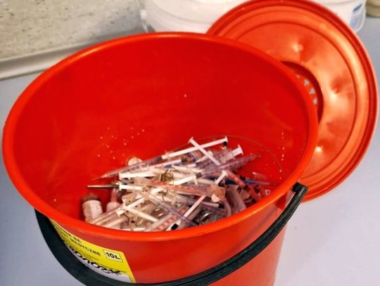 Osiedlowy trawnik „usłany” zakrwawionymi igłami. Strażnicy zebrali pół wiadra strzykawek. ZDJĘCIA